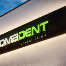 Pomadent sign at night